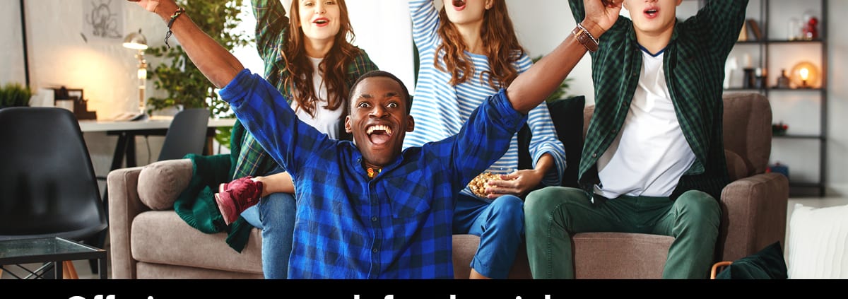 Four young people on a couch cheering. Offering your couch for the night to prevent a friend from driving drunk or high is a winning move.